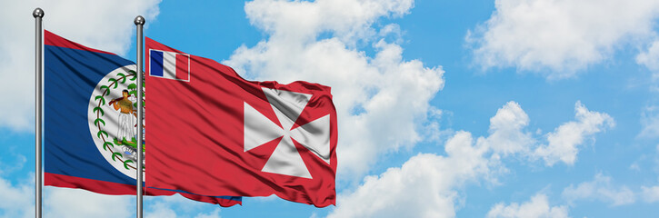 Belize and Wallis And Futuna flag waving in the wind against white cloudy blue sky together....