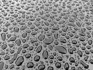 Water droplets from rain On the asphalt tank lid