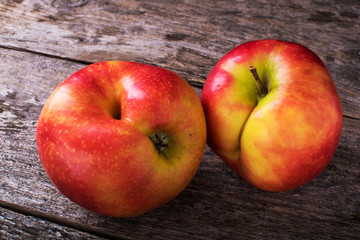 Concept of ugly food - red apple on background