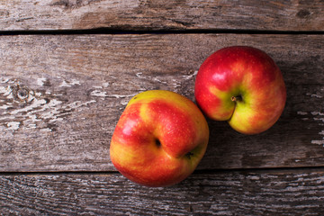 Close-up two ugly red apples on grey concrete background.