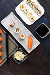 close up of sashimi sushi set with chopsticks and soy - sushi roll with salmon and sushi roll with smoked eel