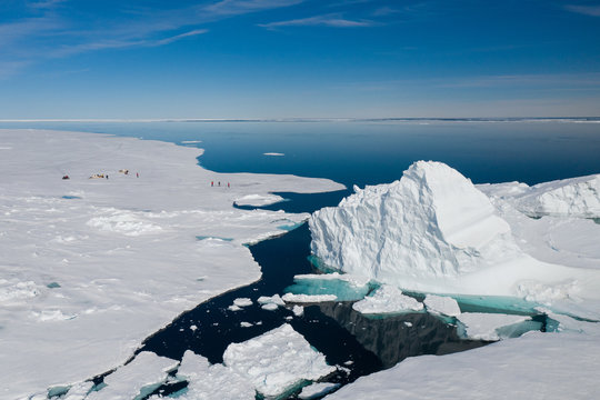Aerial drone photo of tourists visit the floe edge near Sirmilik National Park in Nunavut, Canadaa