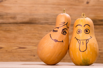 Happy pumpkin family funny faces isolated over rustic wooden background 