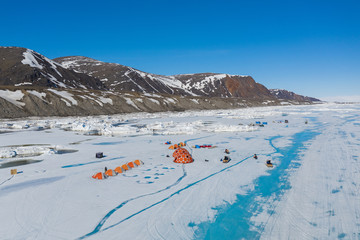 Aerial drone photo of tourists camping on the floe edge near Sirmilik National Park in Nunavut,...