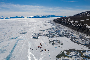 Aerial drone photo of tourists camping on the floe edge near Sirmilik National Park in Nunavut, Canadaa