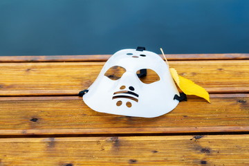 Halloween hockey mask on Boat dock at the lake