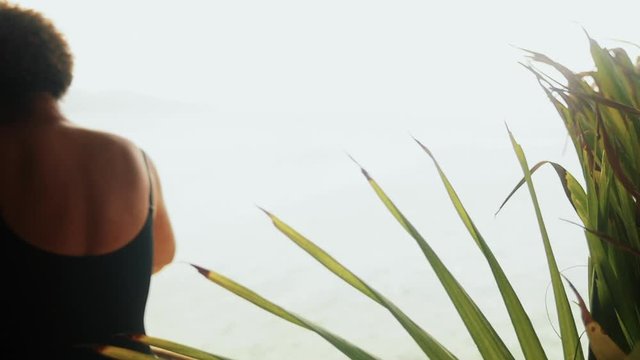 Woman dancing in front of the ocean