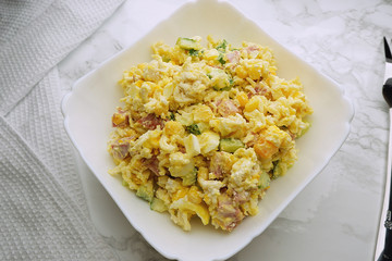 Salad of pasta, bacon, corn, eggs and cucumber