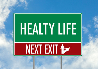 Next exit for healty life green road sign over blue sky background. Concept road sign collection.