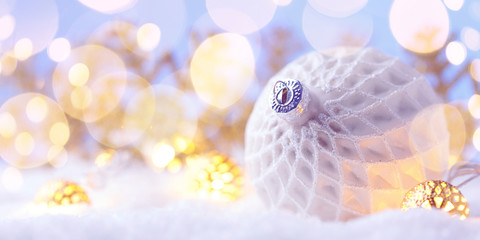 Christmas white ball with snowflakes on snow.