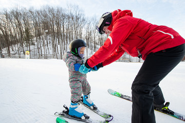 Young girl takes a skiing lesson