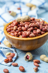 Bowl full of raw peanuts.