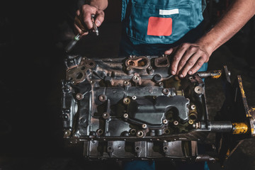 Auto mechanic repairing a car engine. Car maintenance concept.