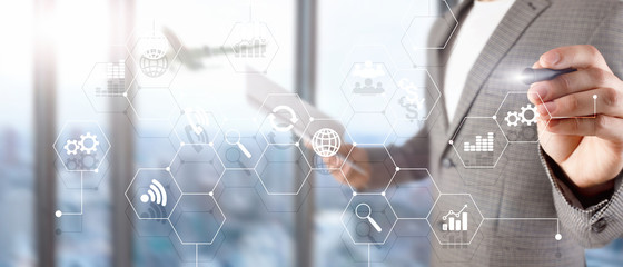 Double exposure mixed media. Diagrams and icons on hologram screen. Business people and modern city on background.