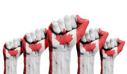 A raised fist of a protesters painted with the Canada flag