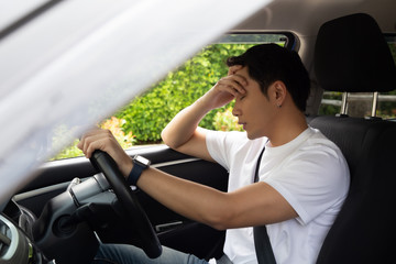 Tired young man sleep in car, Hard work causes poor health, Sit asleep while the car is on a red light, Traffic jam or overworked concept