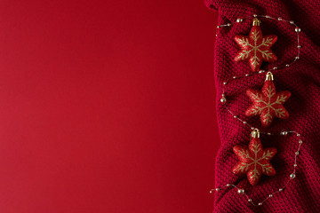 Red christmas background with red christmas toys on red knitted fabric