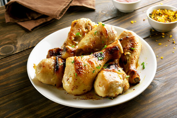 Fried chicken drumsticks on white plate