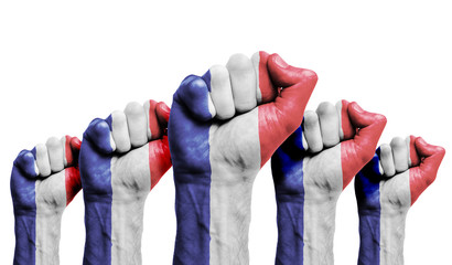 A raised fist of a protesters painted with the France flag