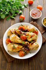 Baked chicken drumstick and roasted tomatoes