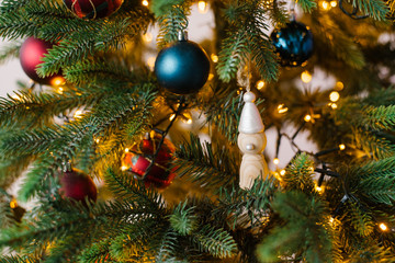 Obraz na płótnie Canvas Christmas tree toys on Christmas tree with lights, close-up