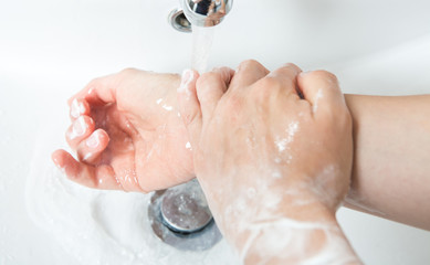 Washing hands with soap under running water. Concept healtcare and medical