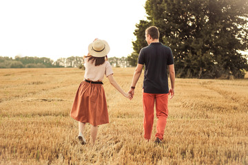 married couple walking in the field