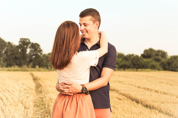 married couple walking in the field