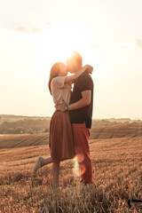 married couple walking in the field