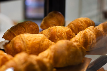 fresh airy crispy croissants in a shop window