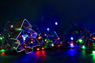Colorful background with flickering light bulbs. Holiday concept. New Year's and Christmas