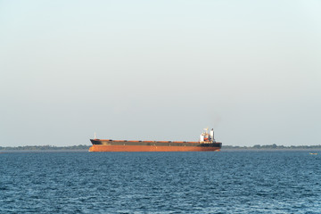 Ships carrying soybeans produced in Brazil for export sailing on the Tapajos River, in sunny days, in the Amazon. Santar&eacute;m, Para. Transport, commerce, environment, agriculture and economy concept.