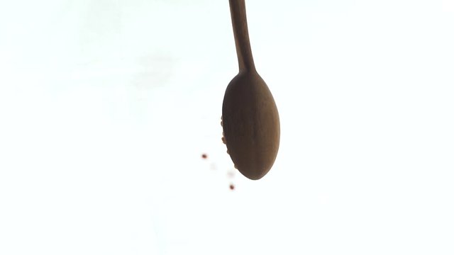 Dropping pigeon peas (pulses) from a wooden spoon