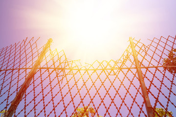 Broken metal razor fence at prison