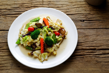 Stir-fried mixed vegetable and mushroom with Oyster sauce on white plate