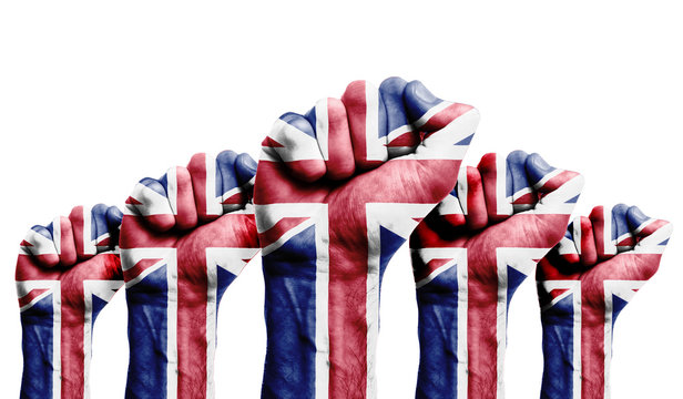 A raised fist of a protesters painted with the UK flag