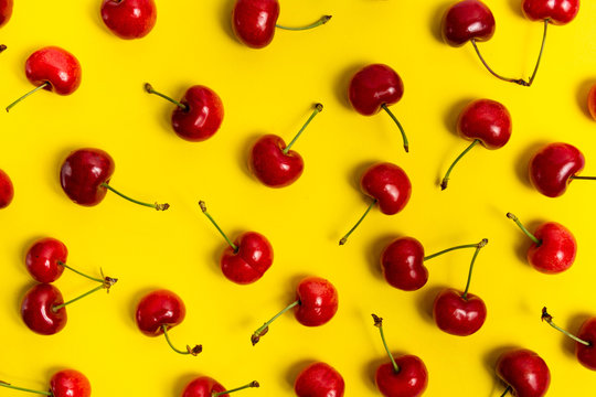Fresh cherry fruit on yellow background