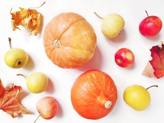 Dry maple leaves, yellow pears, orange pumpkin and red apples flat lay autumn photography. Fall season picture. October harvest