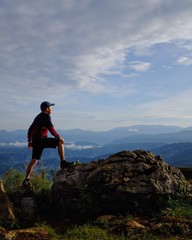 A man on top of a mountain after a hike. Achieving goals. Connect with nature