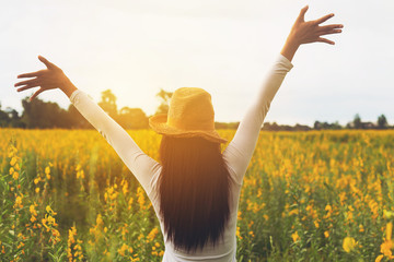 Beauty happy woman raised hands up carefree to sky at bloom blossom agriculture field, - 297653428
