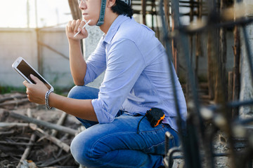 Male architect inspecting building house construction  worker at development site