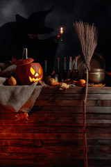 Conceptual image on the theme of Halloween. In the background, a witch in black.