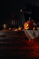 Conceptual image on the theme of Halloween. In the background, a witch in black.