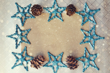 Holiday card. happy New year and merry Christmas. Christmas decor. a fir cone and blue stars on a gray background.