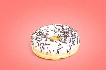 Sweet white donut isolated on pink background