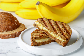 Grilled rye bread sandwich with banana and cream cheese. Delicious healthy Breakfast for adults and children. Selective focus