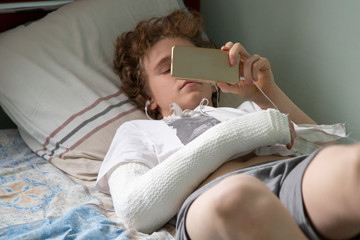 Fototapeta premium A patient with a broken arm is lying in hospital on a bed.