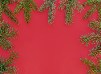 Frame Created Using Green Pine Branches Against Red Background