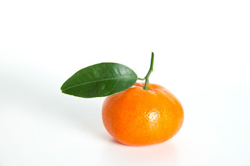 Close up image of one juicy organic whole tangerine with green leaves & visible zest texture, isolated white background, copy space. Macro shot of single bright citrus fruit. Top view, flat lay.