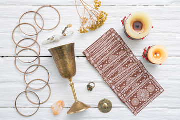 Tarot cards and golden goblet on white table of fortune teller. Divination. Future reading concept.